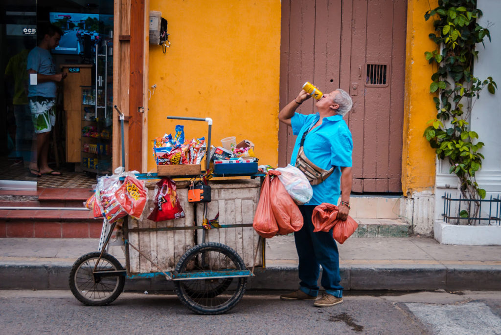 Street vendor drinking from a can - Getsemani