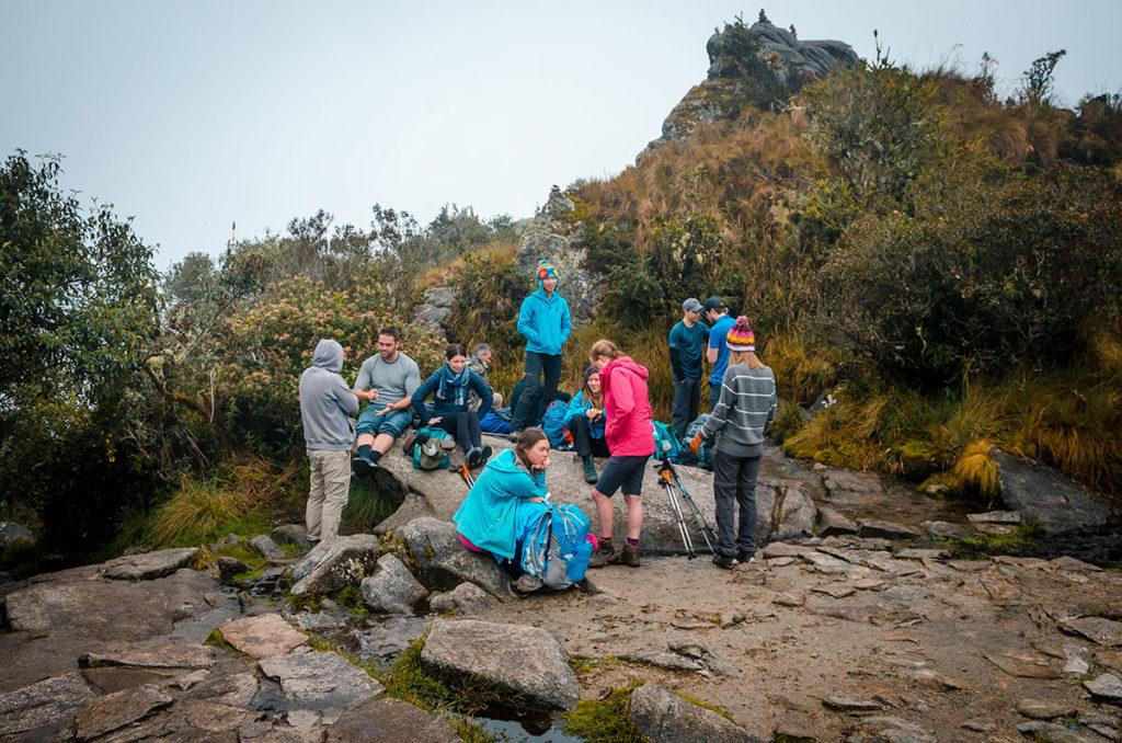 Hikers resting at the Runkurakay Pass - Inca Trail