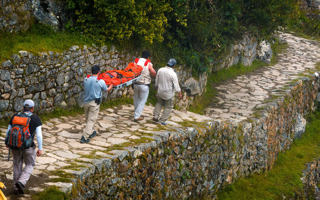Sick girl being carried on a stretcher - Inca Trail