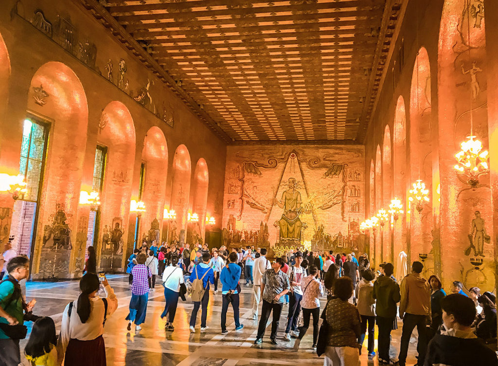Tourists gathered inside the Stockholm's City Hall's Gold Room 