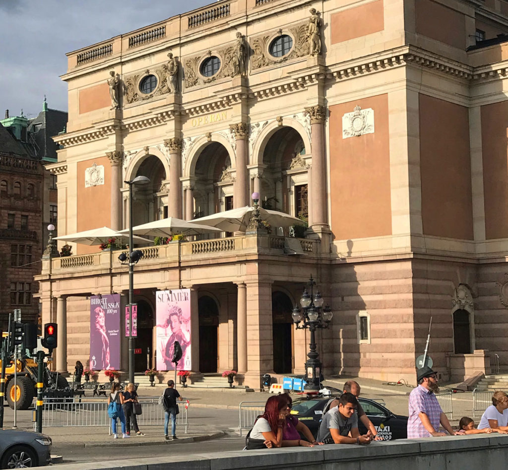 People standing and hanging out outside the Royal Swedish Opera building