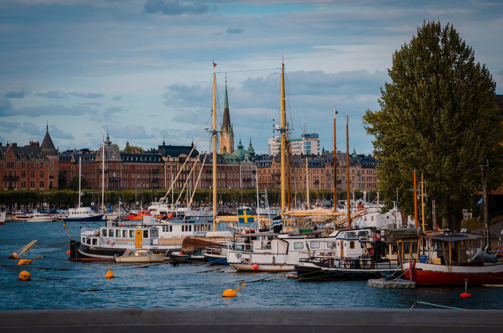 Harbor crowded with boats and surrounded by large buildings