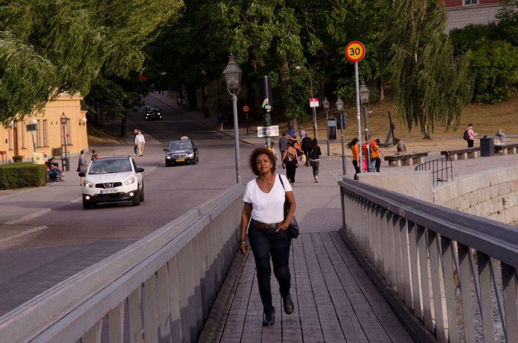 Khadija walking on the Skeppsholmen bridge beside the road