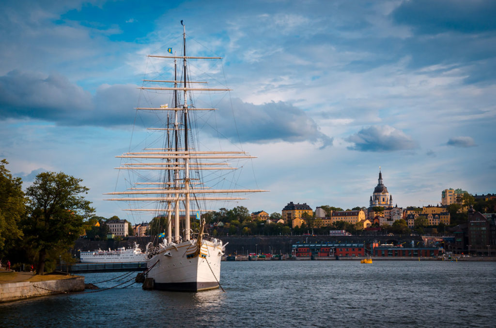 View of a boat stationed on a bay in Sodermalm with beautiful buildings in the background