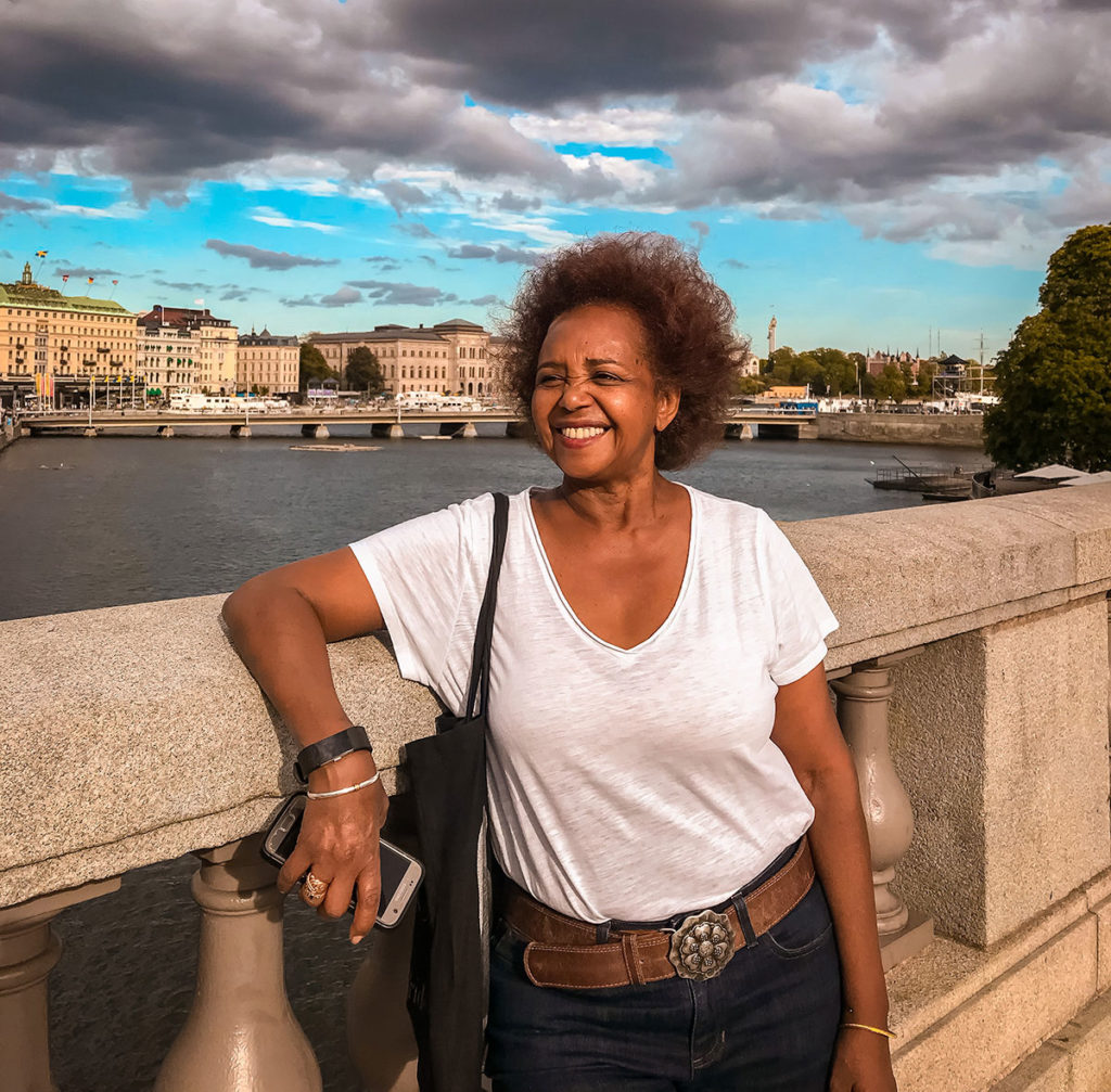 Khadija smiling wide while taking pictures on the Norrbro Bridge