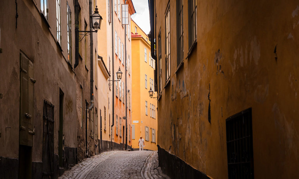Man walking on a narrow Cobblestone street in Stockholm
