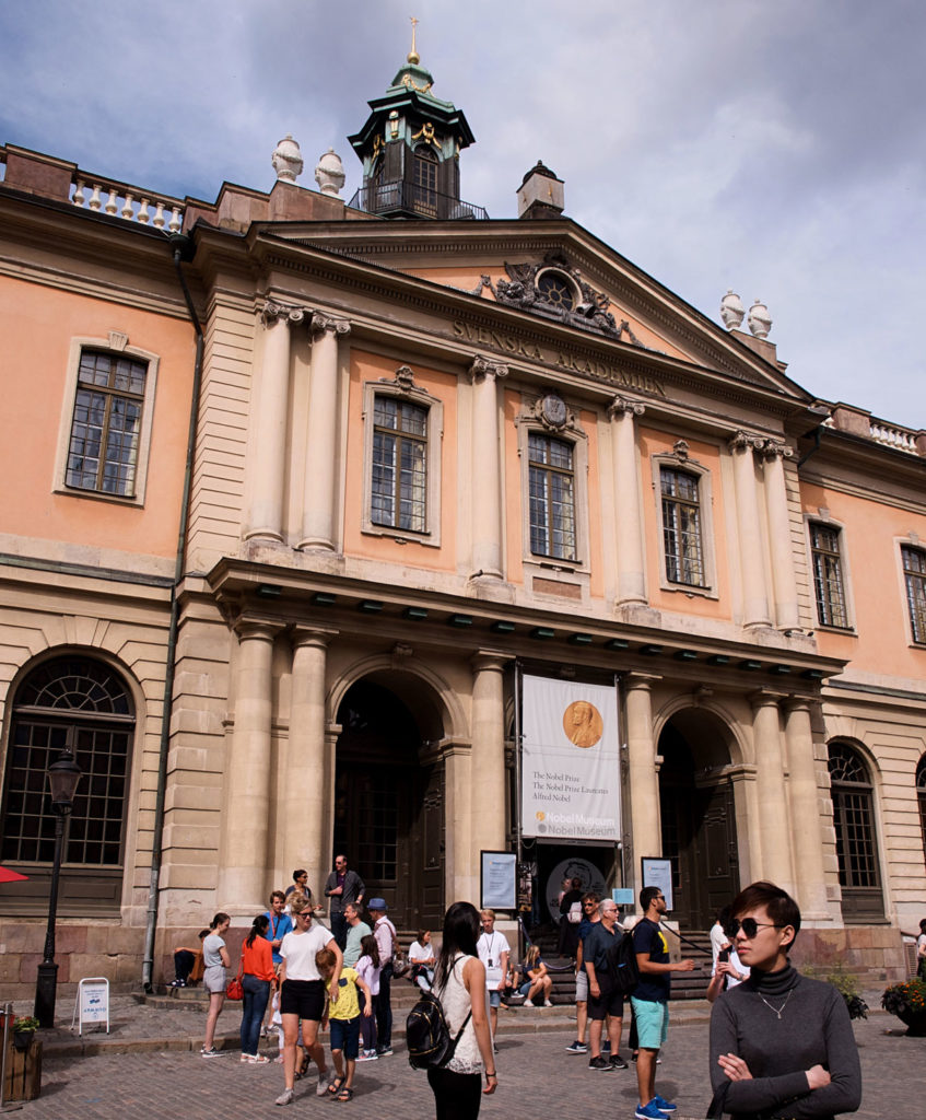 People gathered and standing out the Swedish Academy building