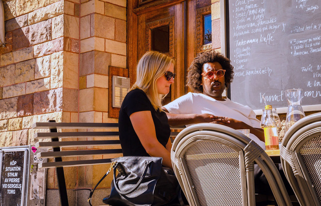 Couple seating and talking outside a cafe is Stockholm