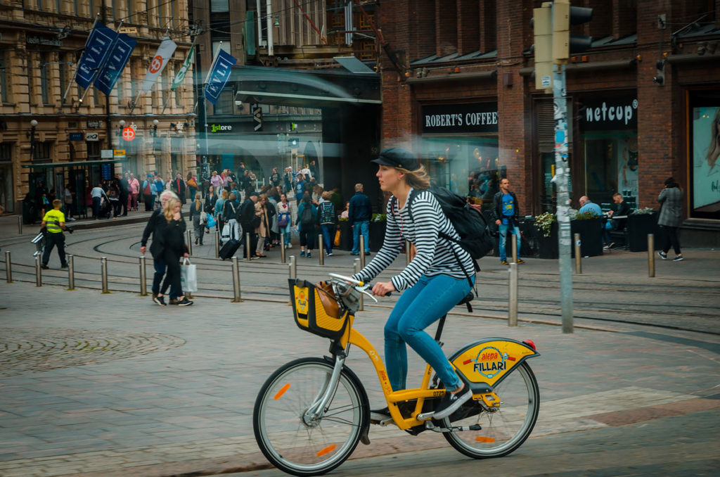 Woman riding a yellow bike - Helsinki