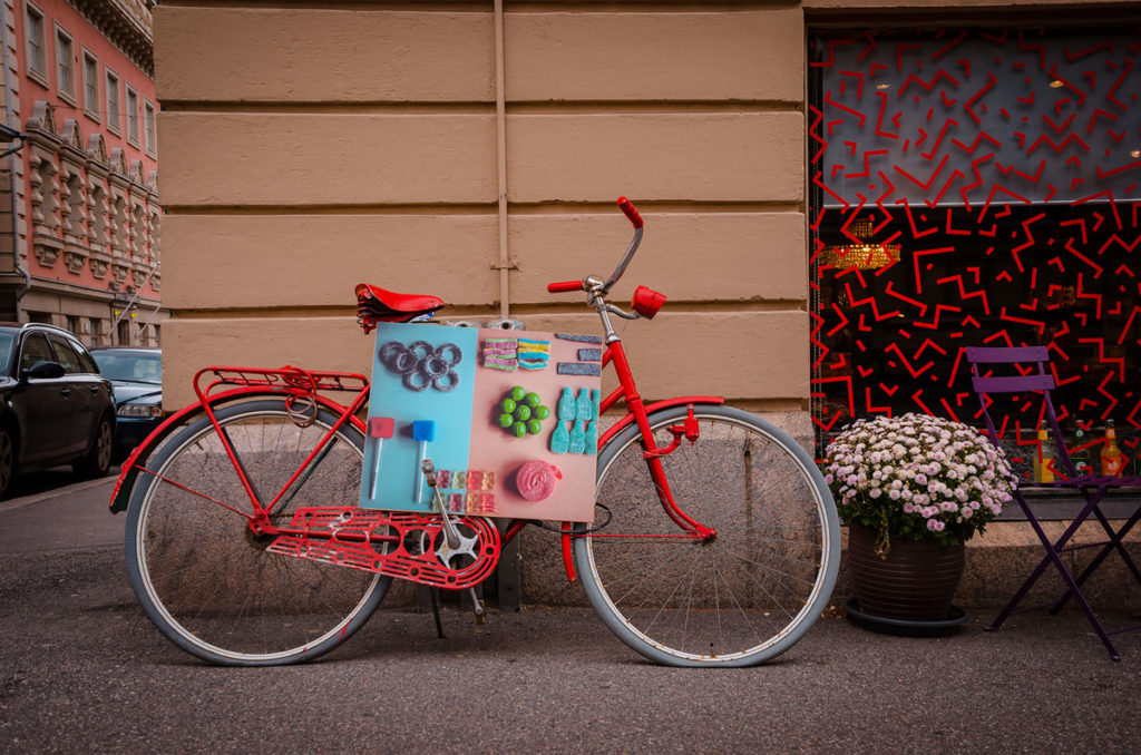 Parked red bicycle with advertising card - Helsinki