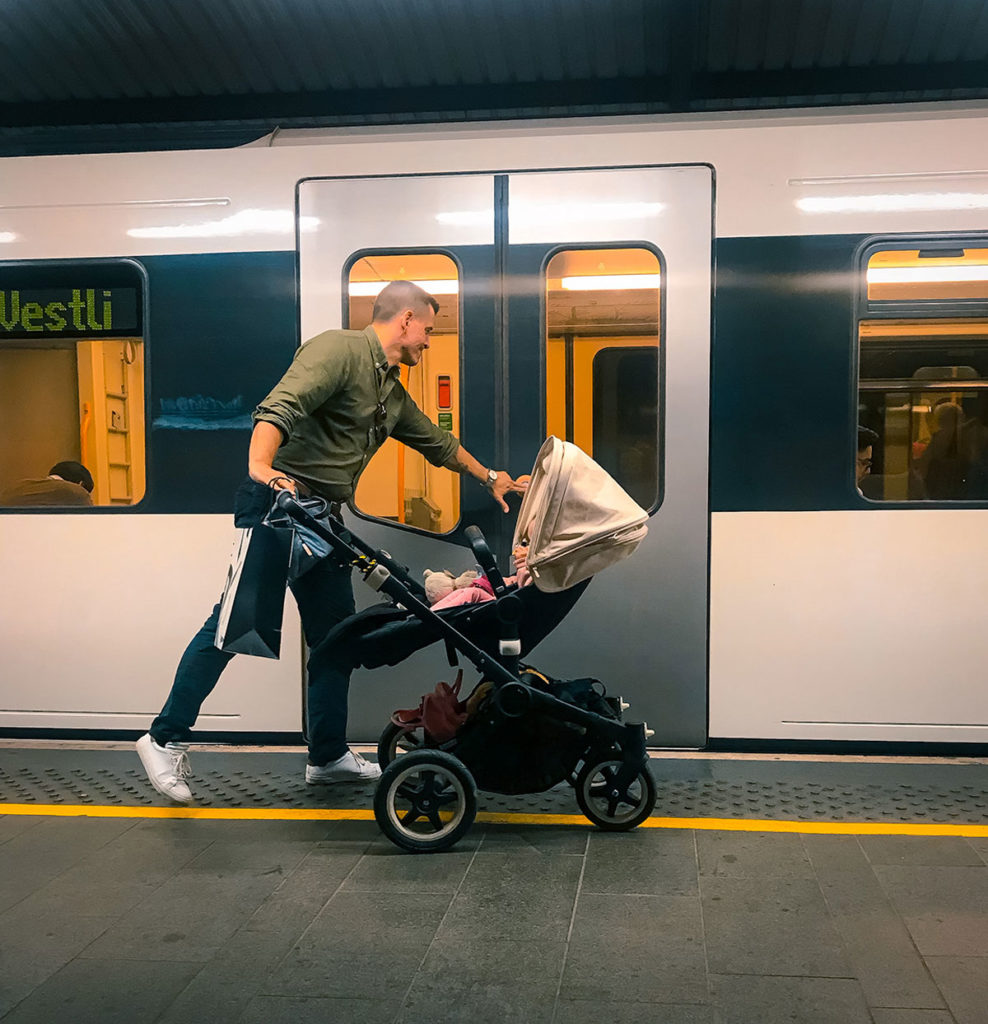 Father with his baby on a stroller entering the train - Oslo