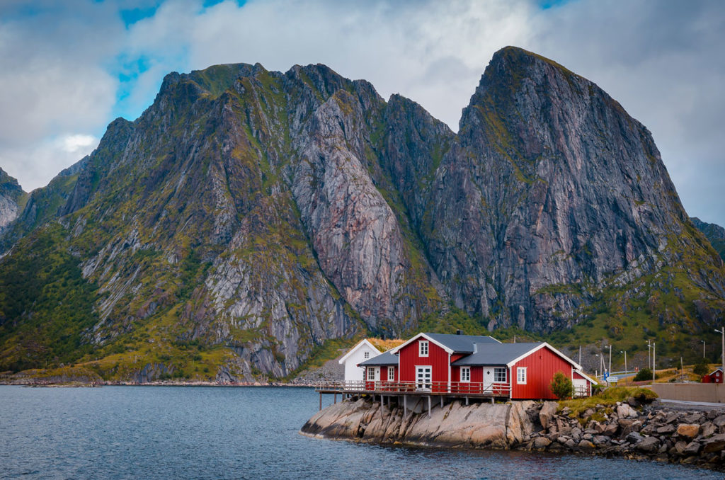 Red house with mountain view on the background - Reine