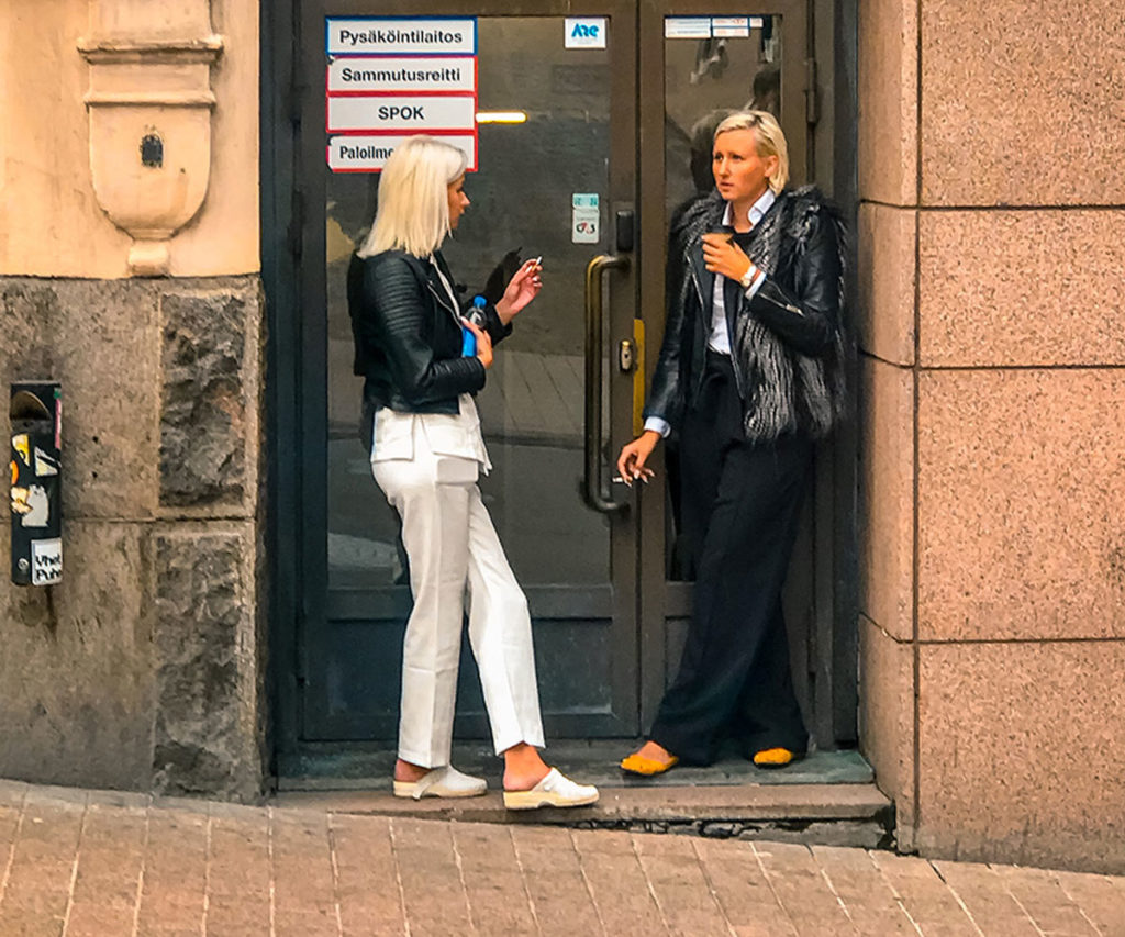 Two women smoking outside a building - Helsinki
