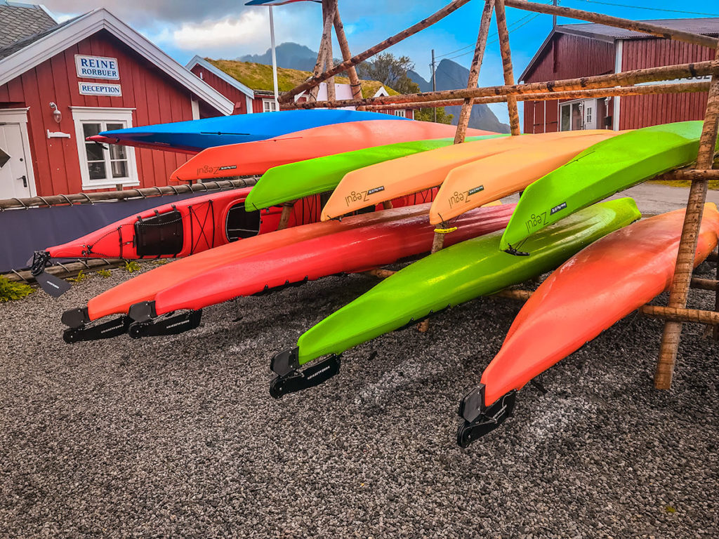 Stacked colorful kayaks - Reine