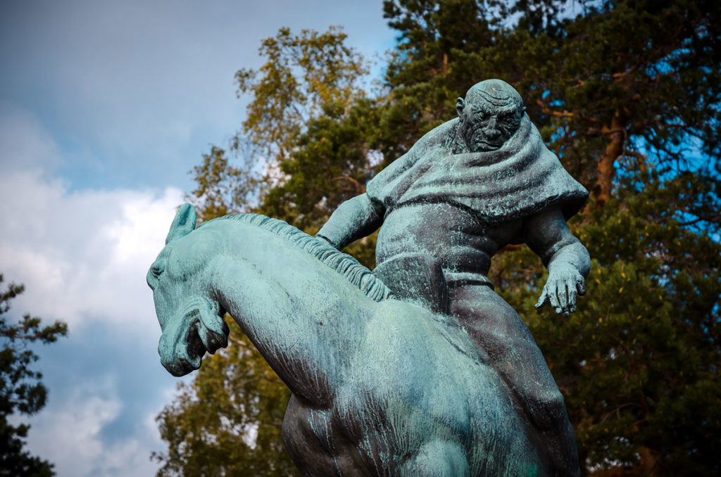 Statue of a bald man riding on a horse in Stockholm