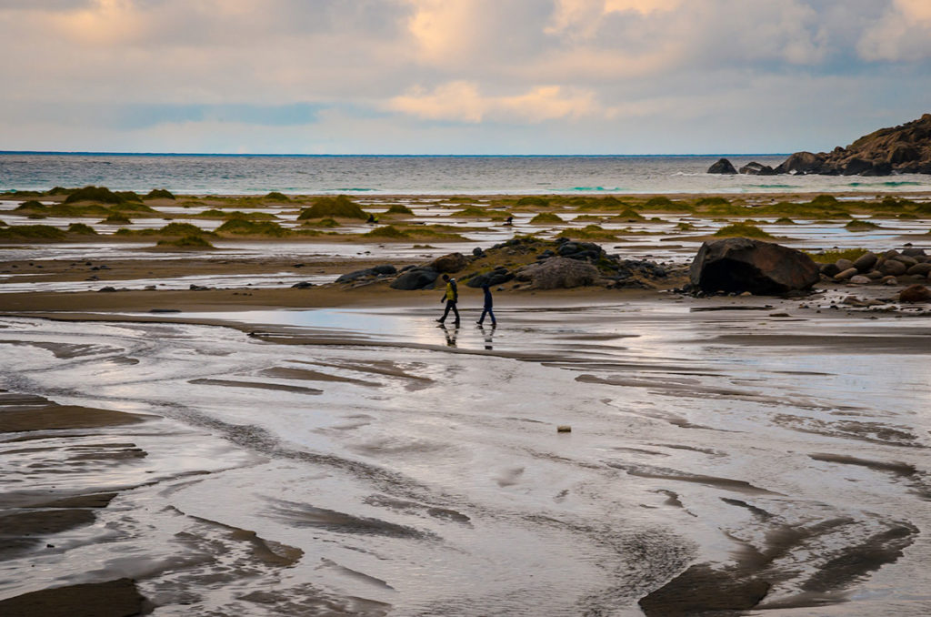 Two men walking by the beach - Bunes Beach