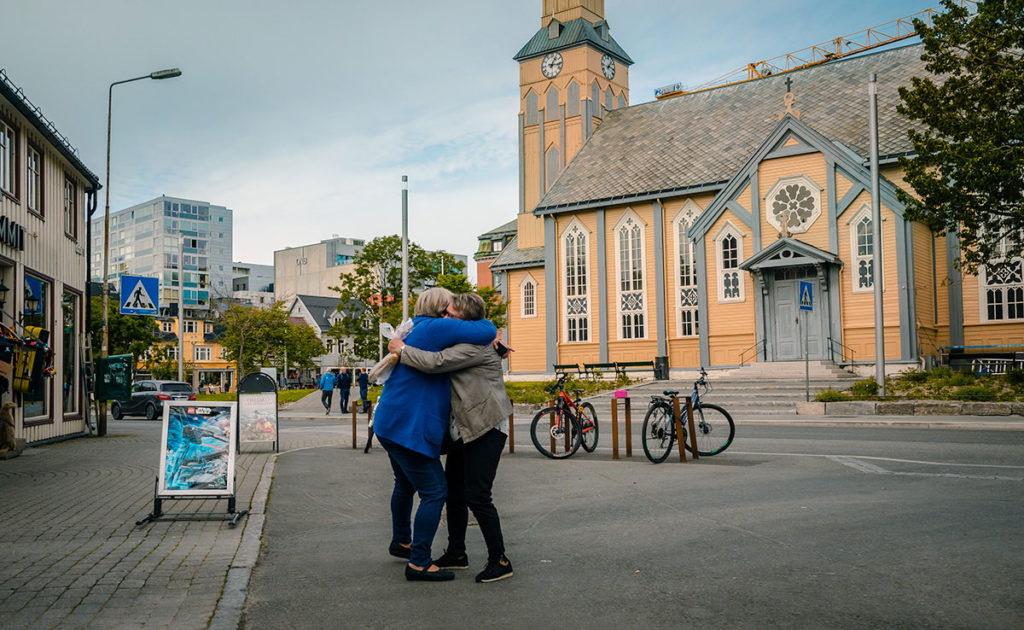 Two elderly friends hugging - Tromsø