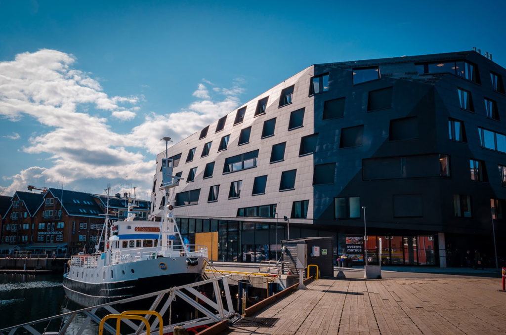 Modern dark grey building along the bay - Tromsø