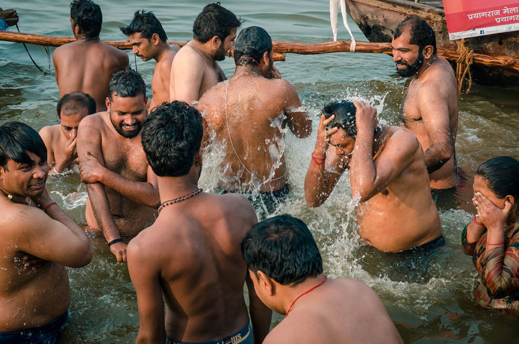 Group of men bathing in the river - India