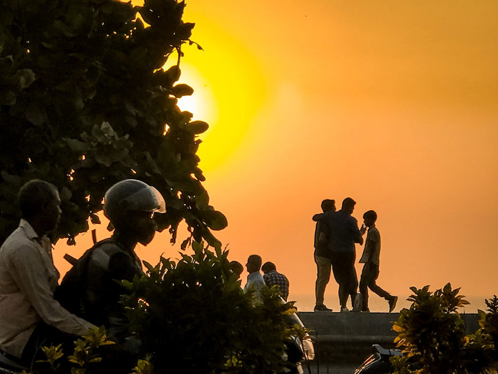People in front of a sunset view - Mumbai