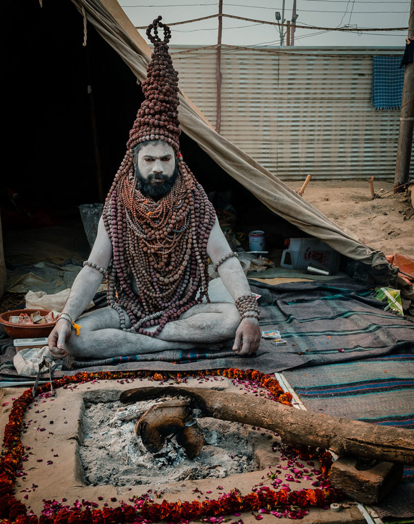 Sadhu with heavily-beaded accessories - India