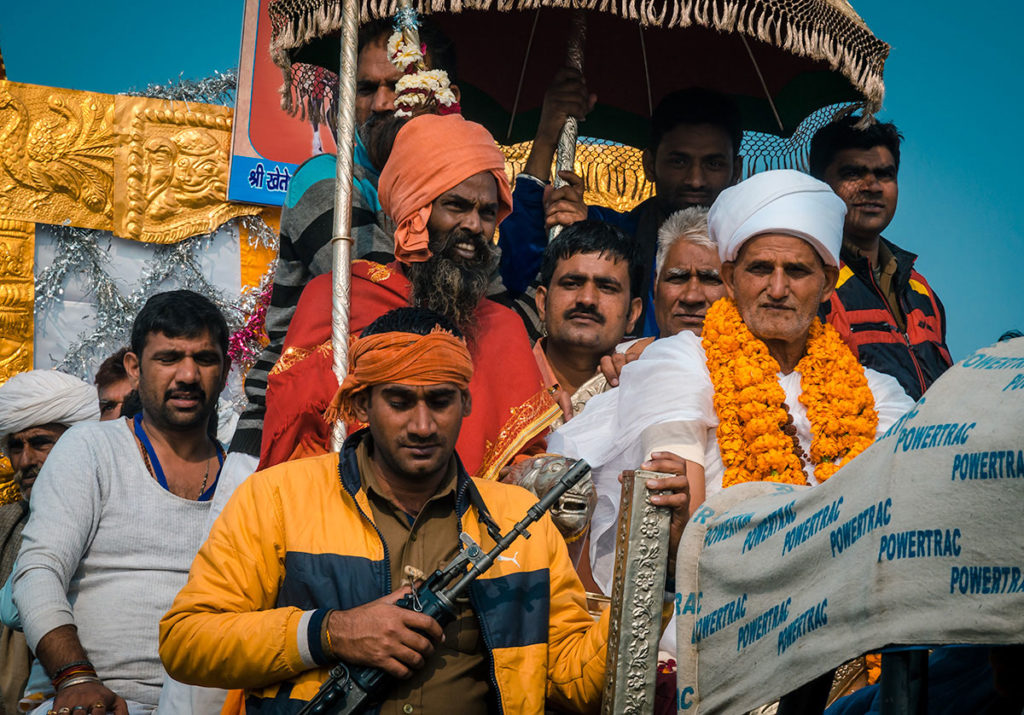 Pilgrim riding a float during a Kumbh Mela parade - India