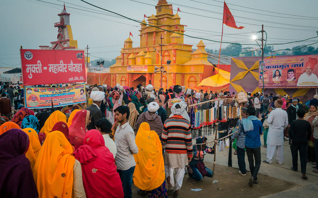 Crowd in front of a brightly colored gateway - India