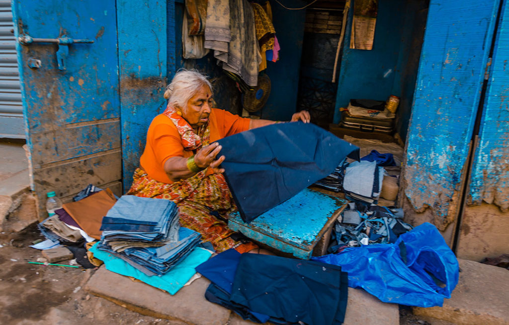 Elderly woman sorting fabrics - Dharavi