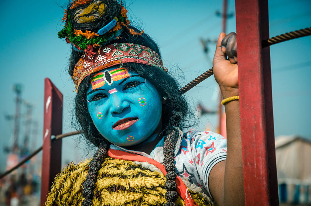 Face-painted girl dressed as a deity - India