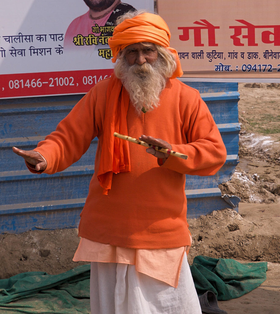 Dancing Sadhu on orange traditional clothing - India