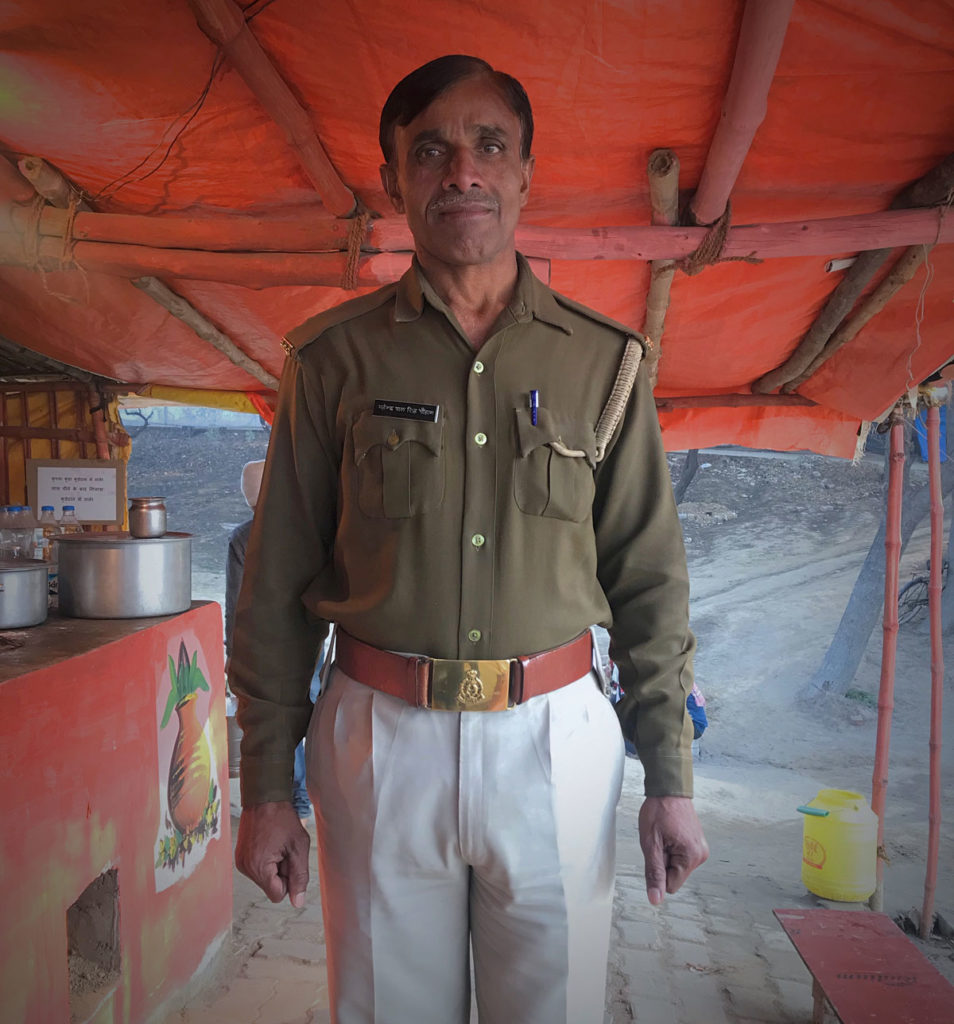 Policeman in front of a Chai stand - India
