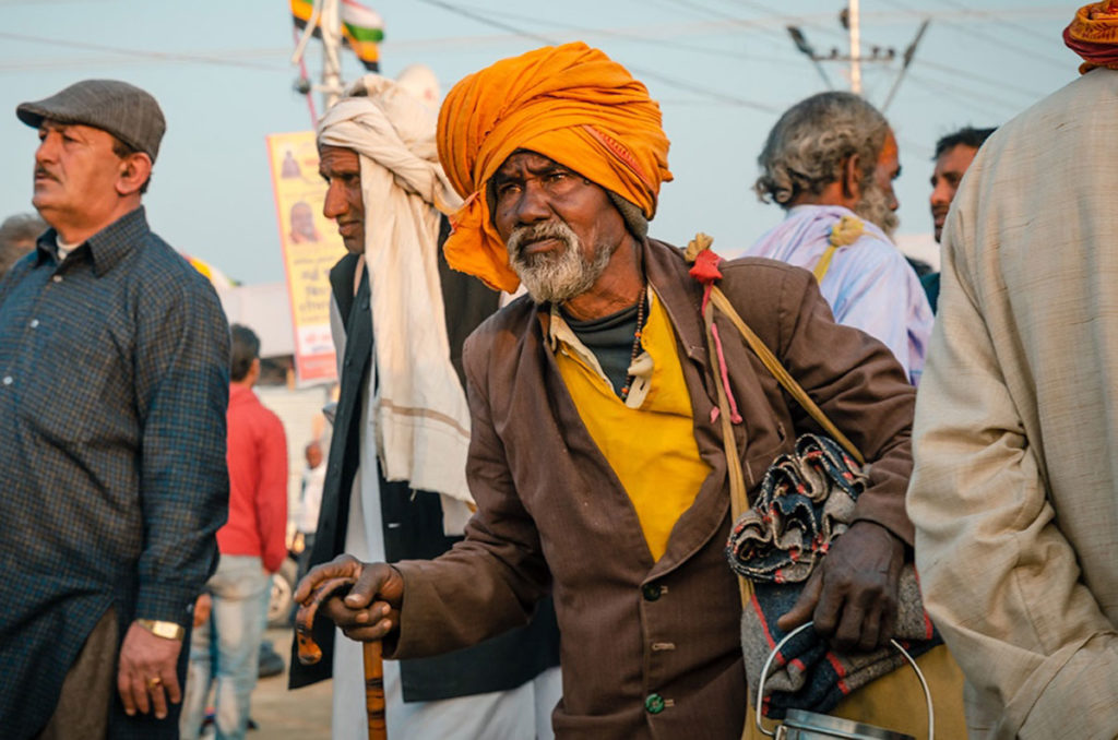 Sadhu walking on the street with other pilgrims - India