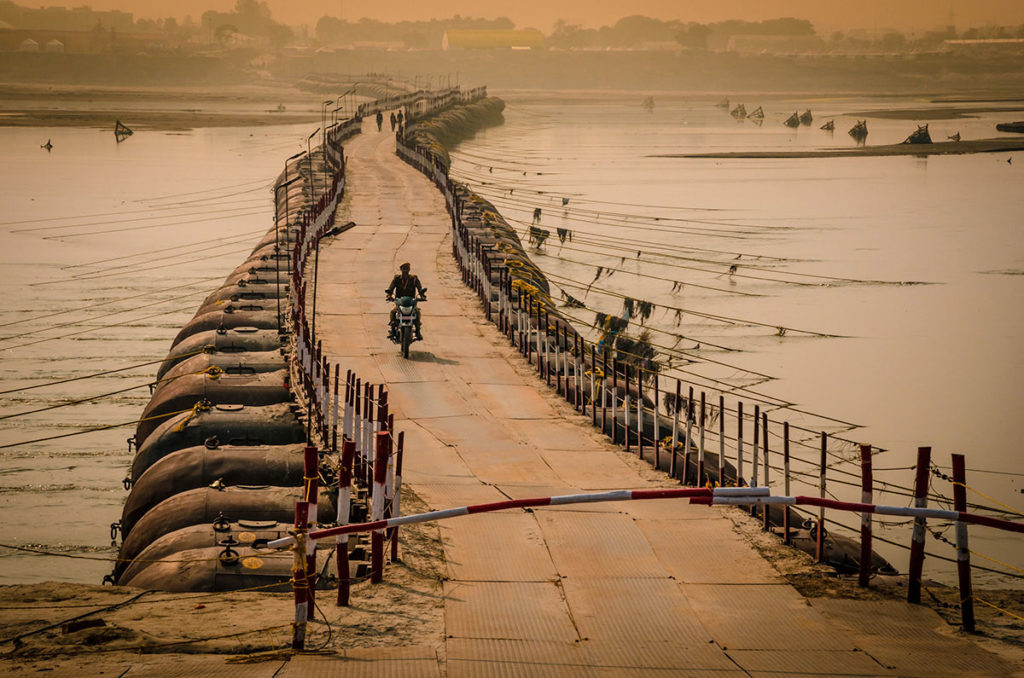 Motorcycle rider on a Pontoon bridge - India