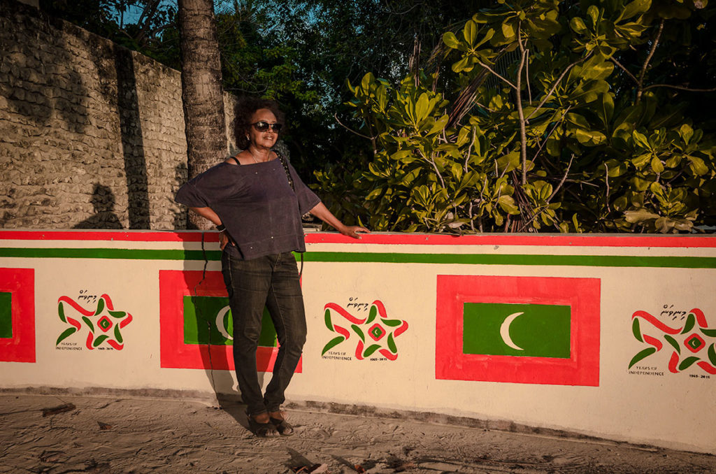 Khadija by a commemorative wall - Dhigurah