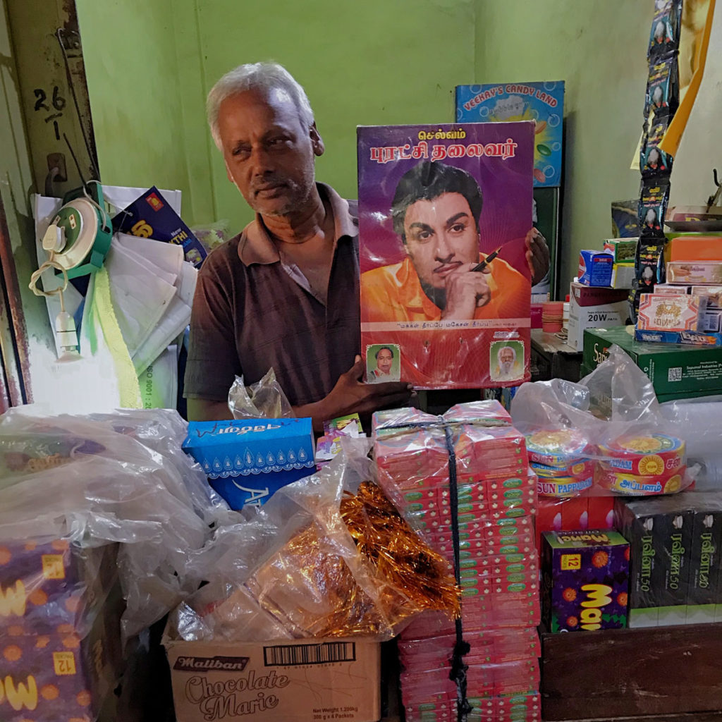 Vendor showing a portrait of his young self - Jaffna City