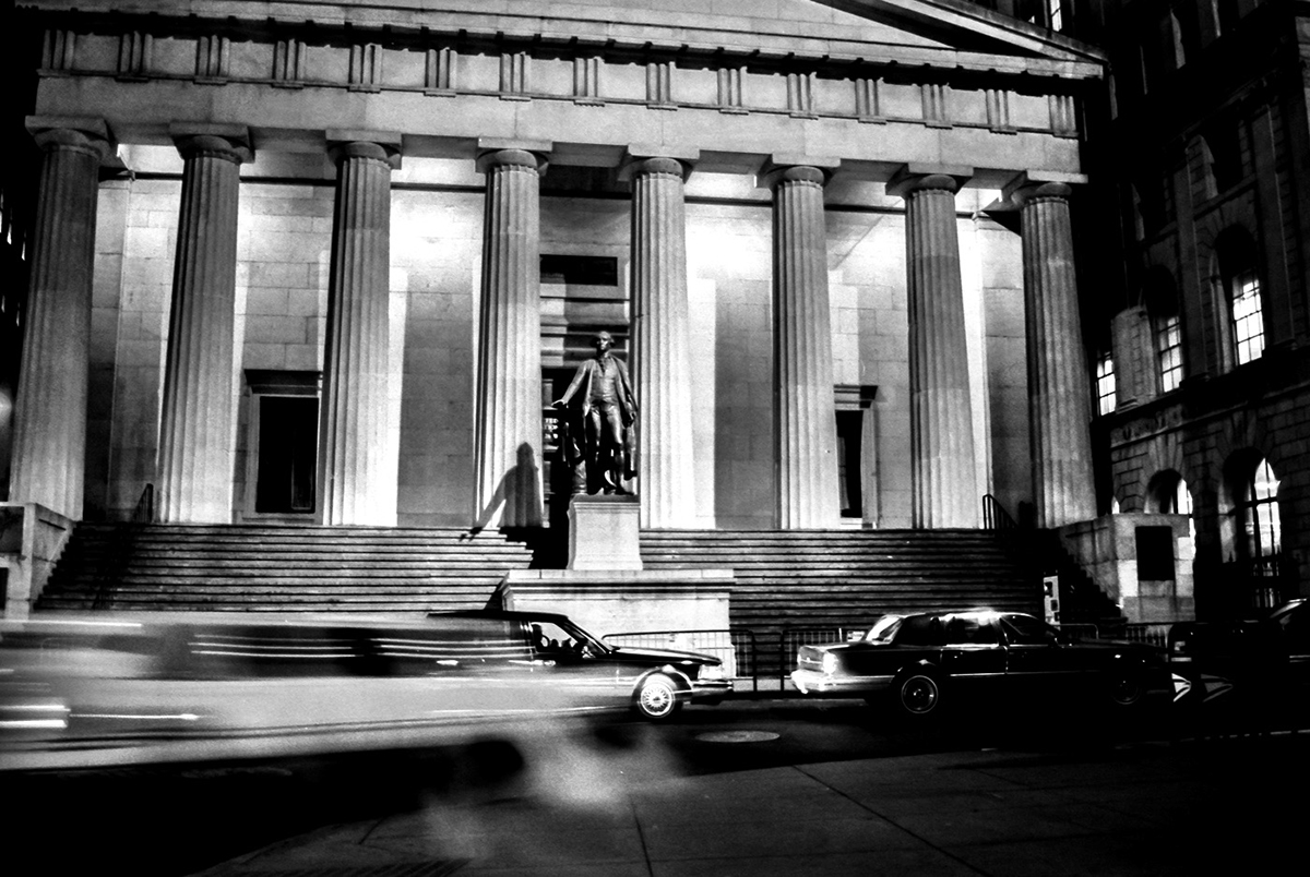Cars passing in front of the Federal Hall at Night
