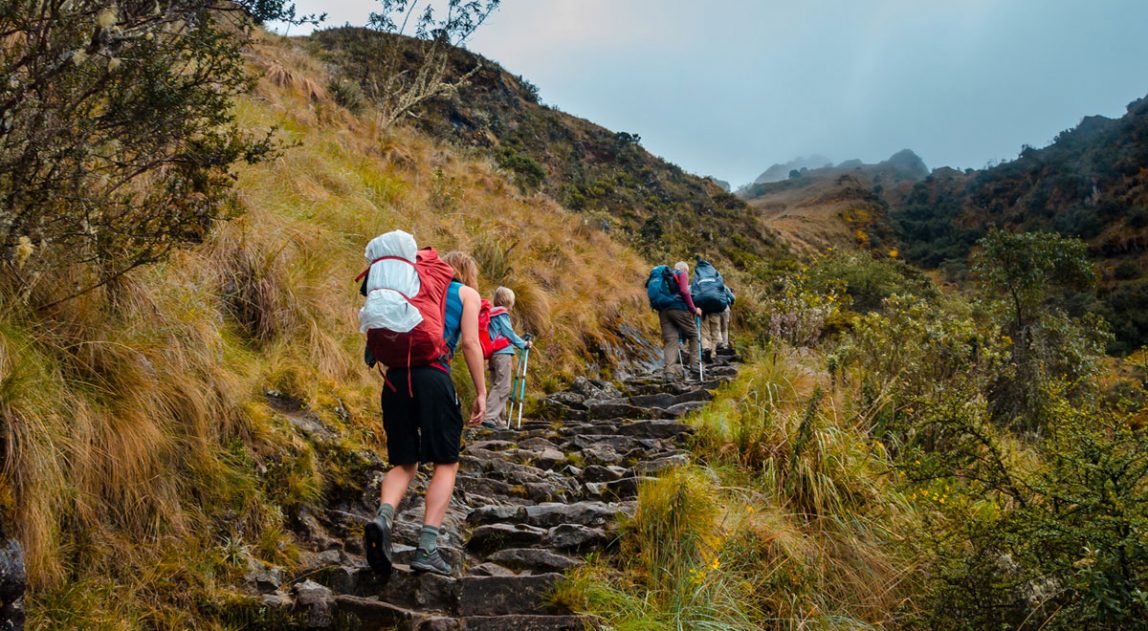 Hikers climbing steps to Runcuracay Pass - Inca Trail